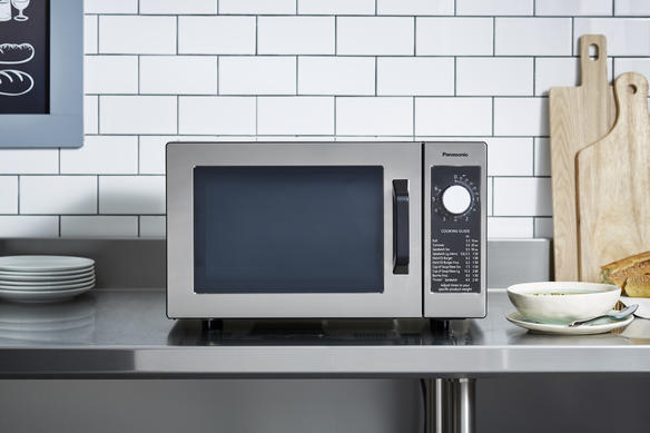 microwave on countertop with food head on